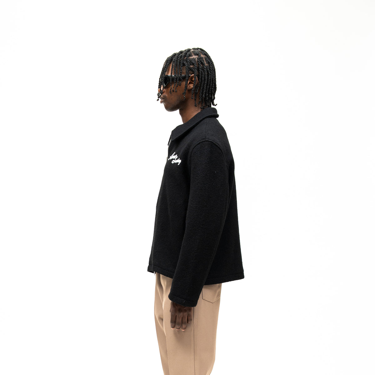 Saint Cropped Wool Jacket – Black – Side view on model showing collar, long sleeve, and straight cropped silhouette