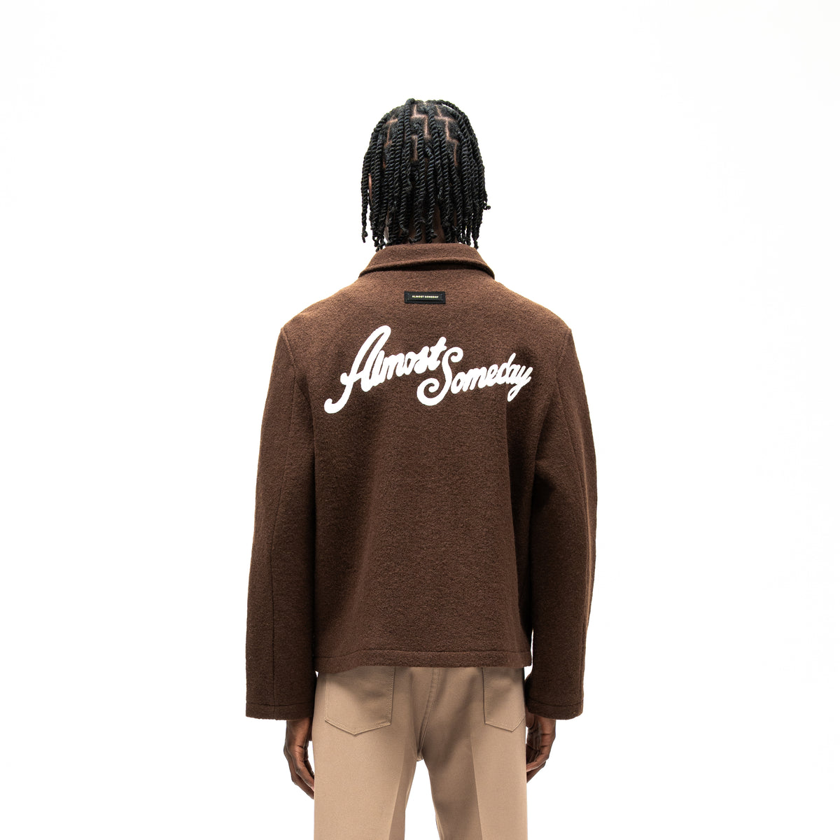 Saint Cropped Wool Jacket – Brown – Back view on model showing large white Almost Someday script and small label beneath collar