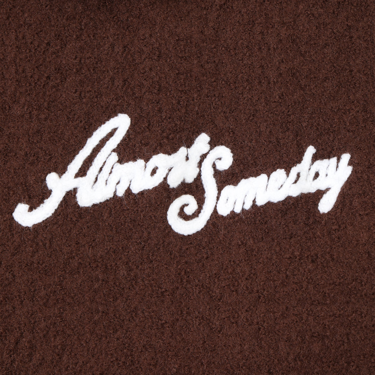 Saint Cropped Wool Jacket – Brown – Close-up of white Almost Someday script chest logo