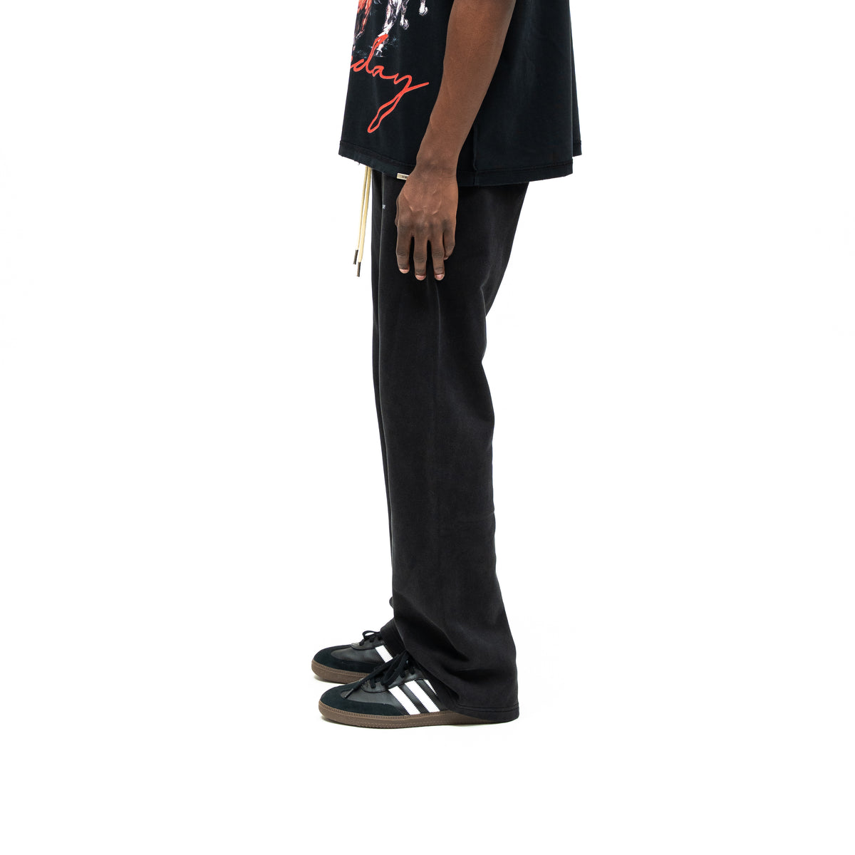 Smoke Flare Bottoms – Black – Side view on model styled with graphic tee, showing plain leg profile and flared hem
