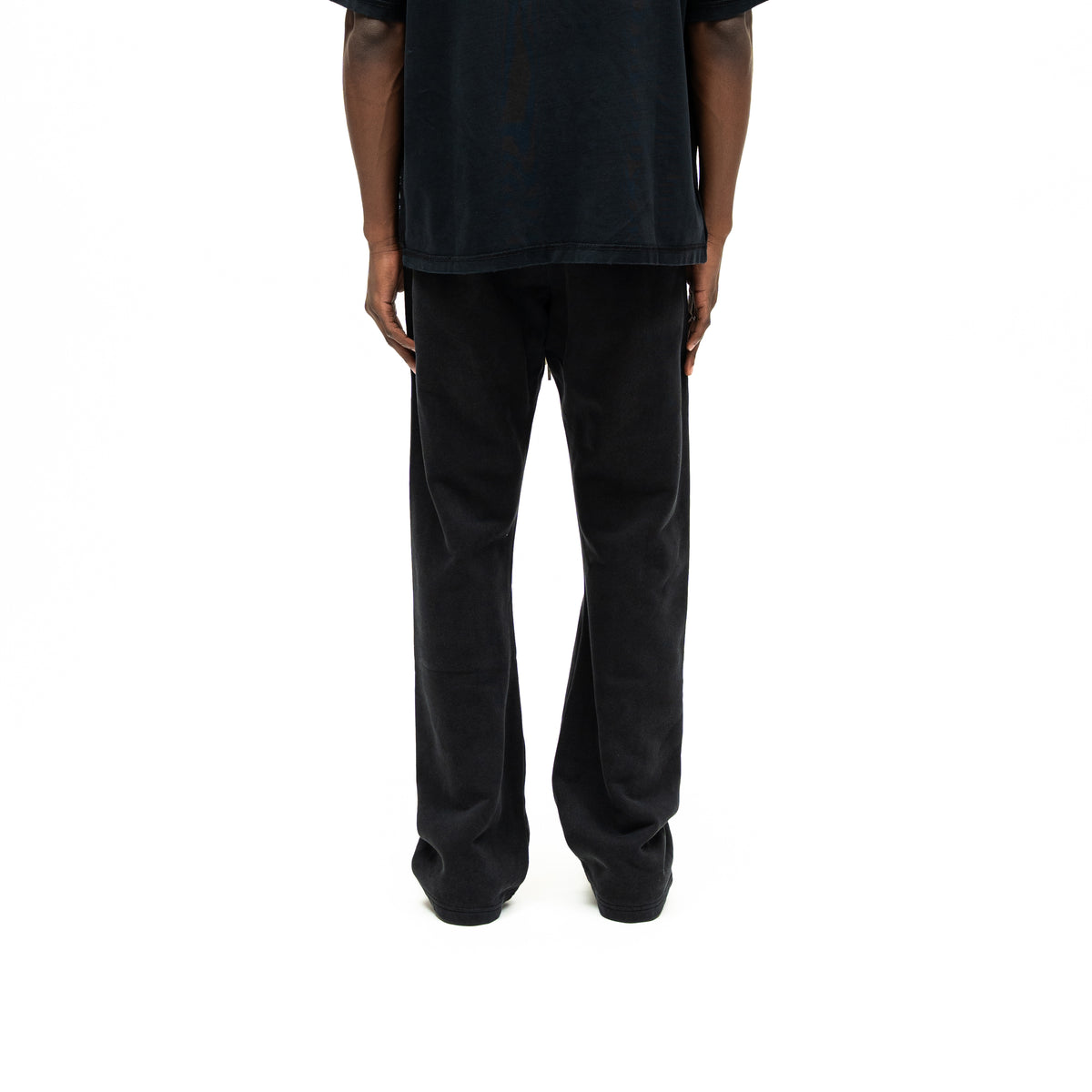 Smoke Flare Bottoms – Black – Back view on model styled with black tee, showing plain back and flared hems