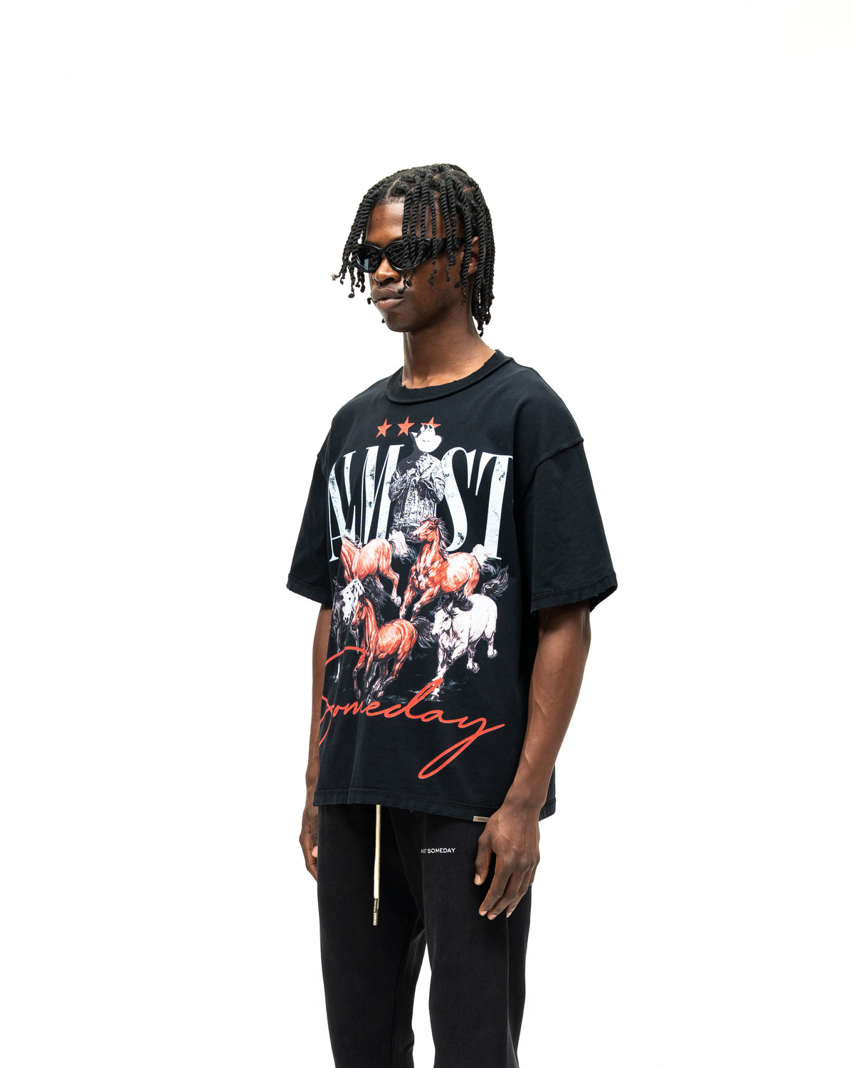 Smoke Tee – Black – Three-quarter front view on model showing large horse graphic and wide short sleeves