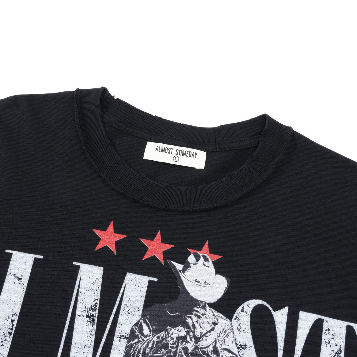 Smoke Tee – Black – Close-up of ribbed crew neckline, Almost Someday neck label, and red stars above cowboy artwork