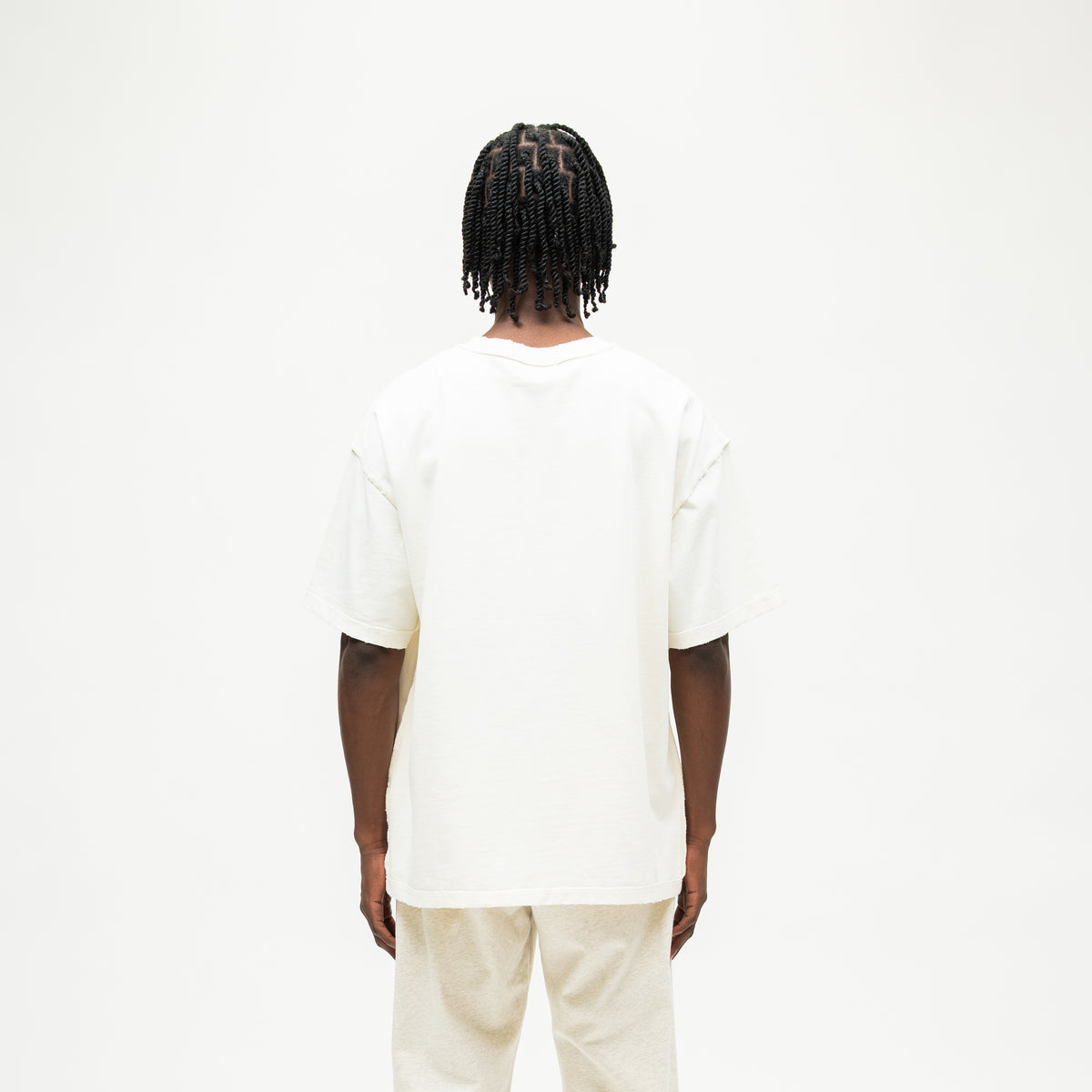 Smoke Tee – Cream – Back view on model showing plain cream back and relaxed silhouette