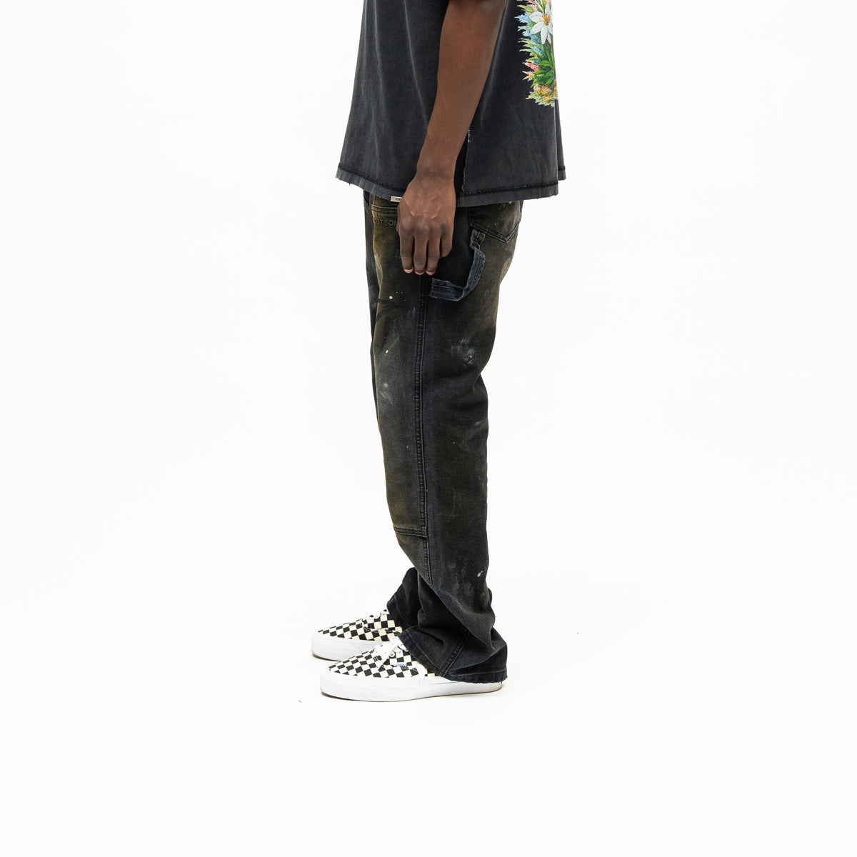 Spade Pants – Black – Side view on model showing utility loop, stitched leg panels, and washed finish