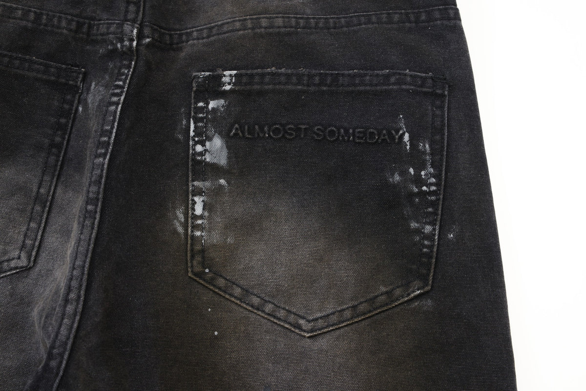 Spade Pants – Black – Close-up of rear patch pocket with tonal Almost Someday lettering and faded finish