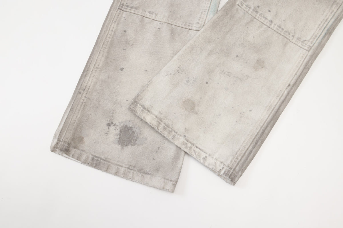 Spade Pants – Cream – Close-up of overlapping leg hems showing panel stitching and mottled finish