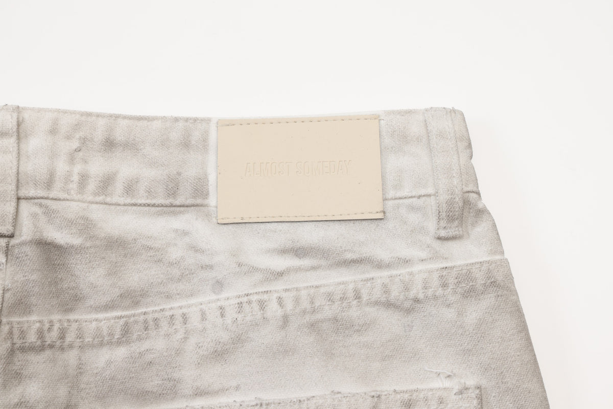 Spade Pants – Cream – Close-up of cream rectangular waistband patch, belt loops, and back yoke seam