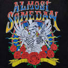 T-shirt design with a skeleton playing guitar surrounded by roses and 'Almost Someday' text.