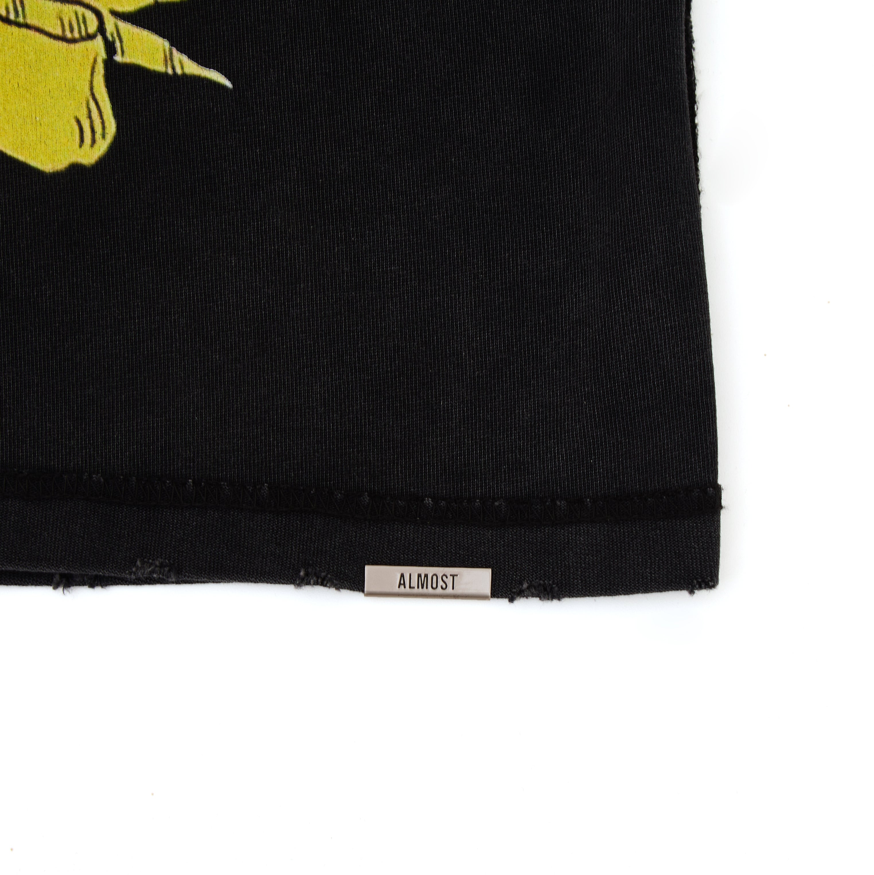 Black fabric with a yellow graphic and 'ALMOST' label on a white background