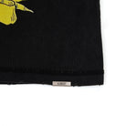 Black fabric with a yellow graphic and 'ALMOST' label on a white background