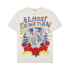 Cream t-shirt with colorful graphic design featuring a skeleton, roses, and text on a white background