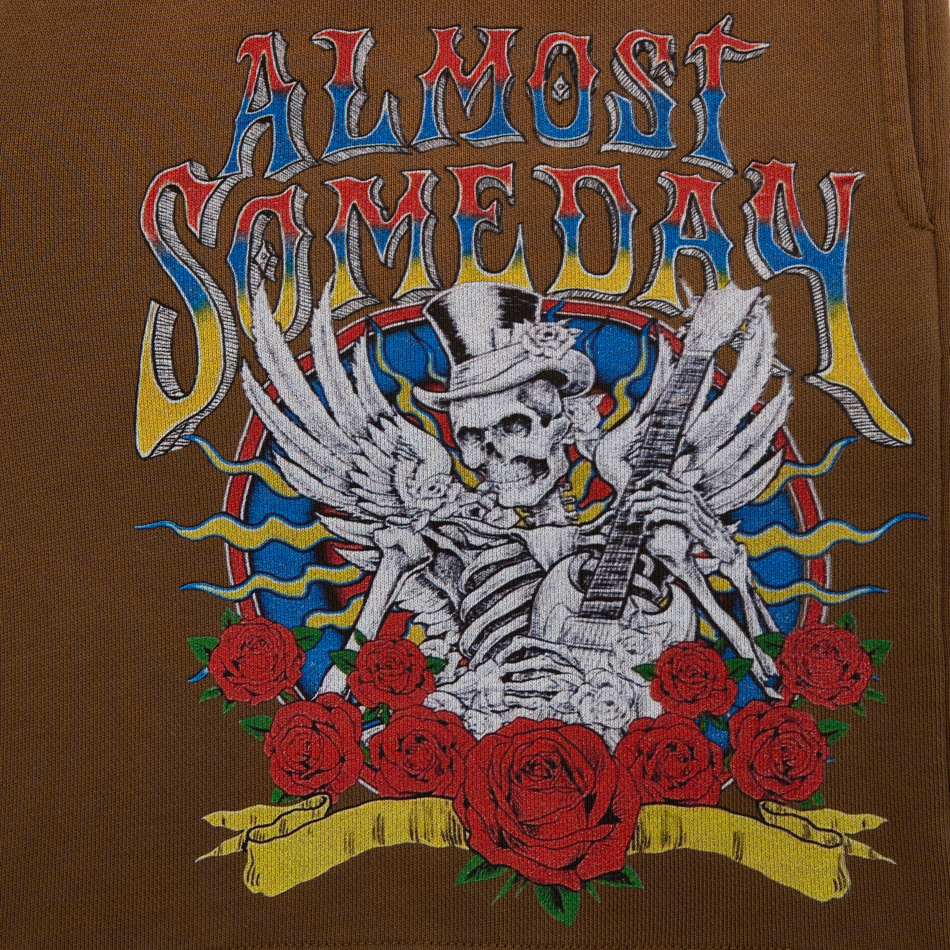 Embroidered design on a brown background featuring a skeleton with a guitar, roses, and colorful text.