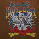 Embroidered design on a brown background featuring a skeleton with a guitar, roses, and colorful text.