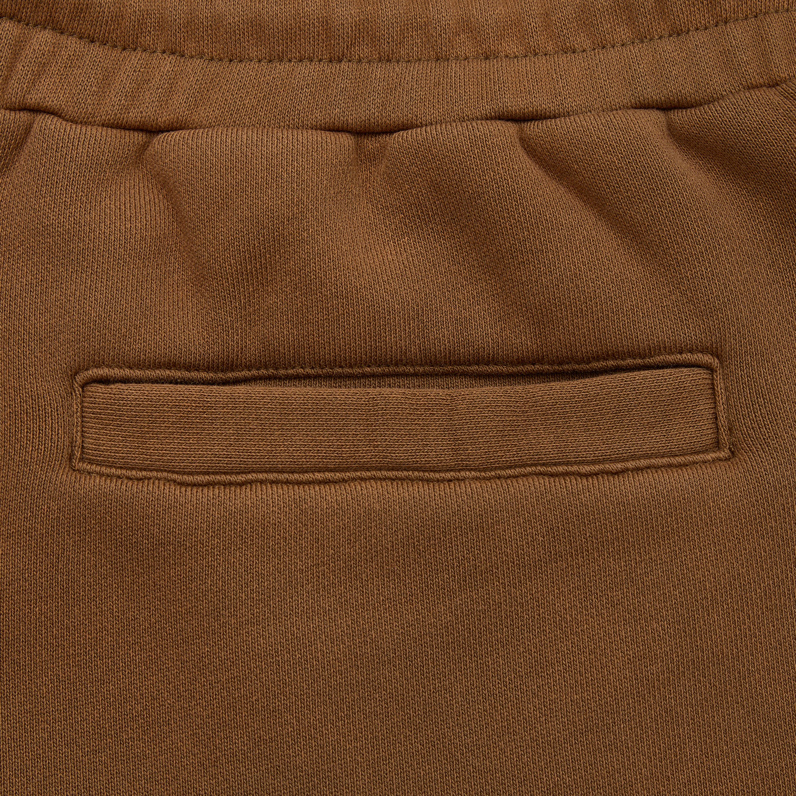 Close-up of brown fabric with a pocket