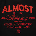 Black shorts with red ALMOST SOMEDAY text and branding on a black background