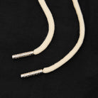 Beige cord with silver ends on a black background