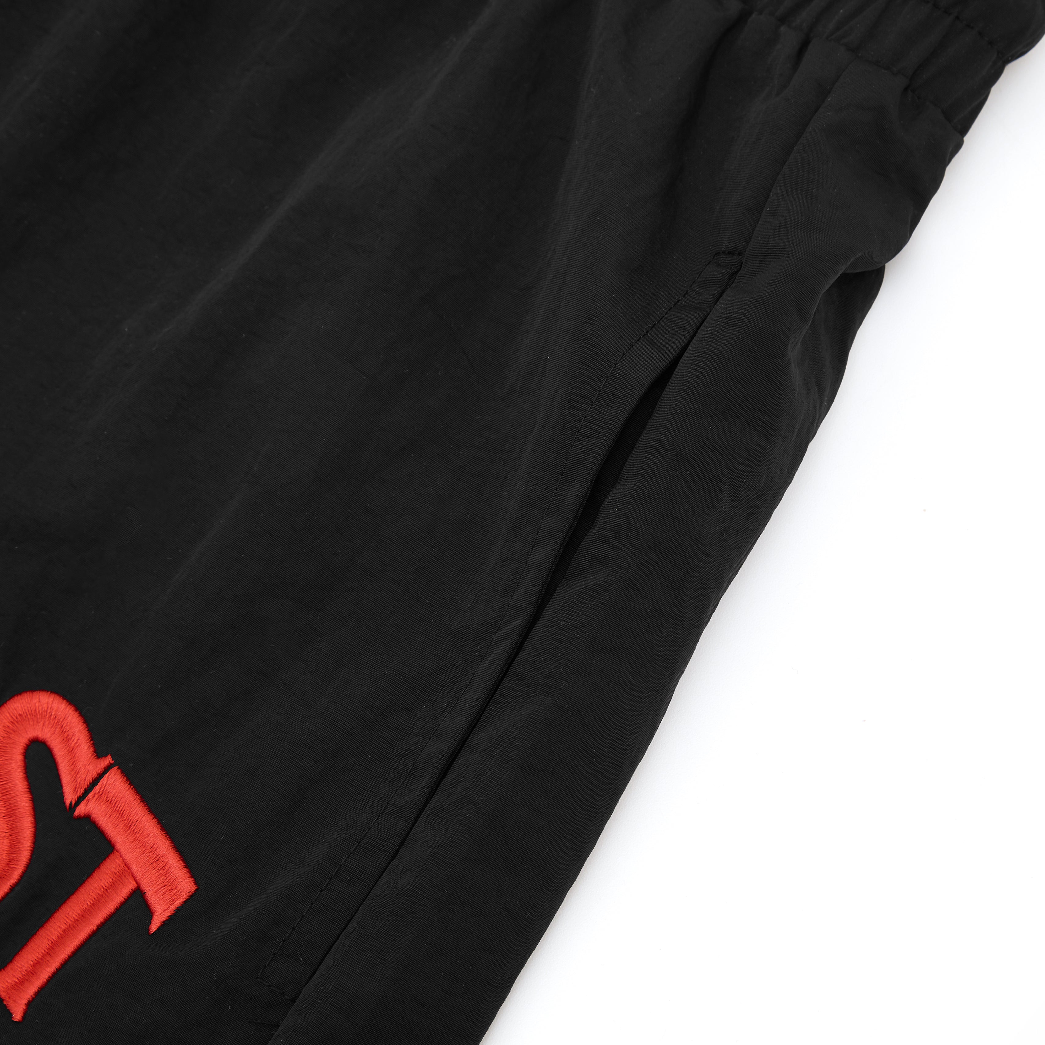 Black pants with red logo on a white background