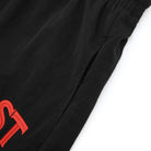 Black pants with red logo on a white background