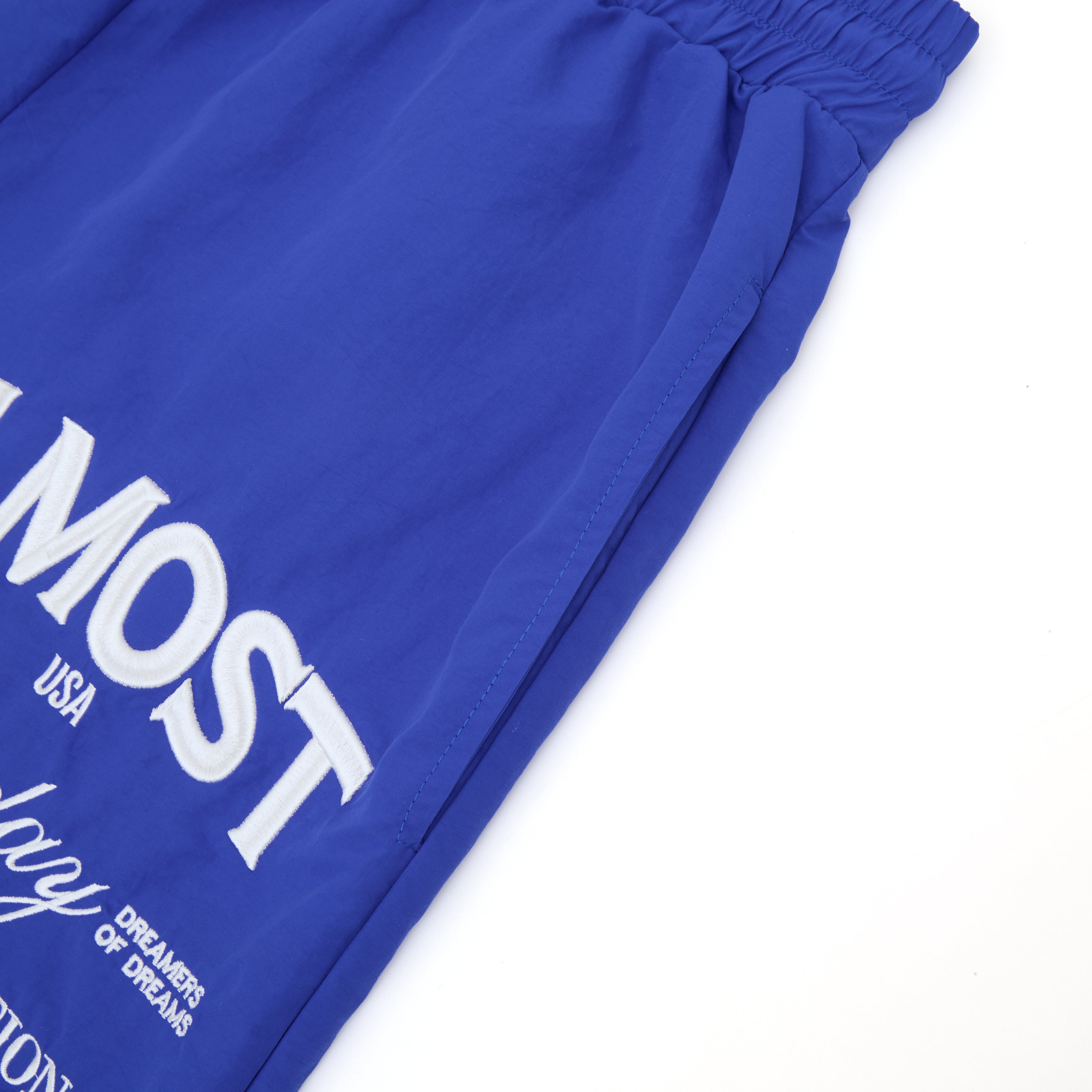 Blue shorts with white text on a white background