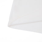 Close-up of a cream tshirt on a white background