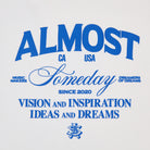 Blue graphics on a cream tshirt with Almost Someday' branding elements.