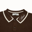 Brown polo shirt with white trim and 'Almost' branding on a white background
