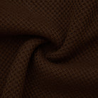 Close-up of brown textured fabric with a subtle pattern