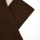 Brown textured fabric on a white background