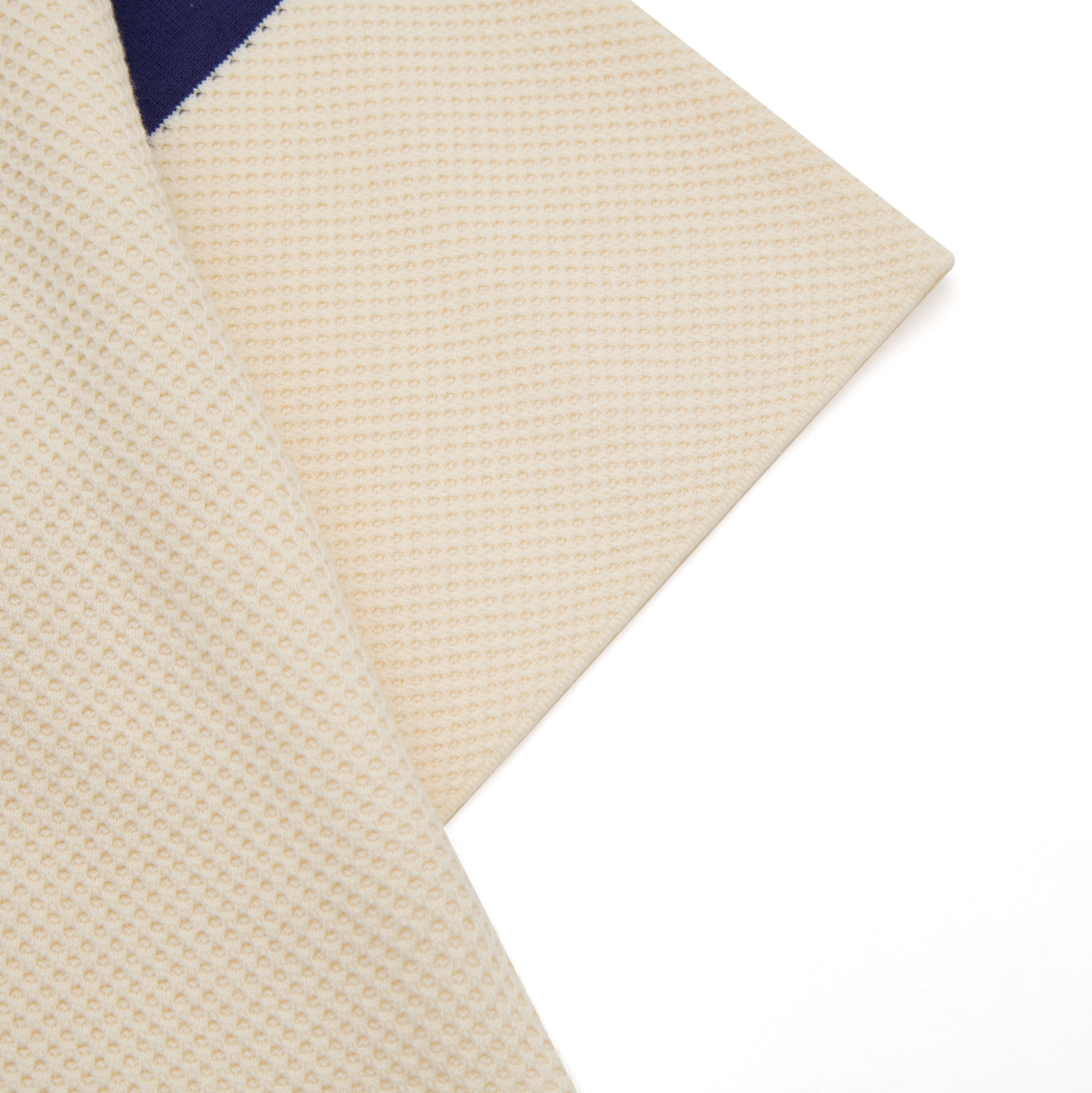 Close-up of a textured beige fabric with a white background