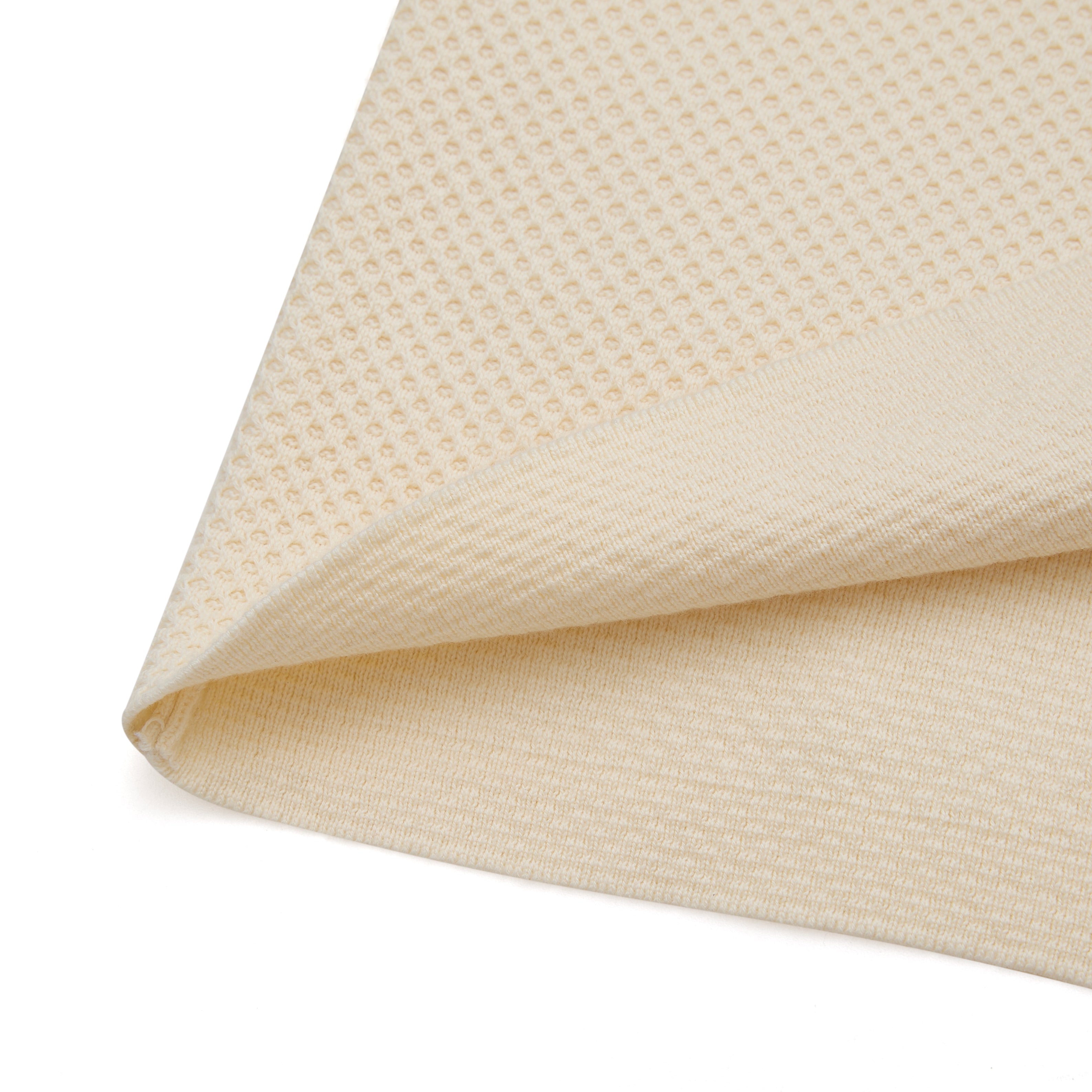 Close-up of beige textured fabric on a white background