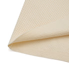 Close-up of beige textured fabric on a white background