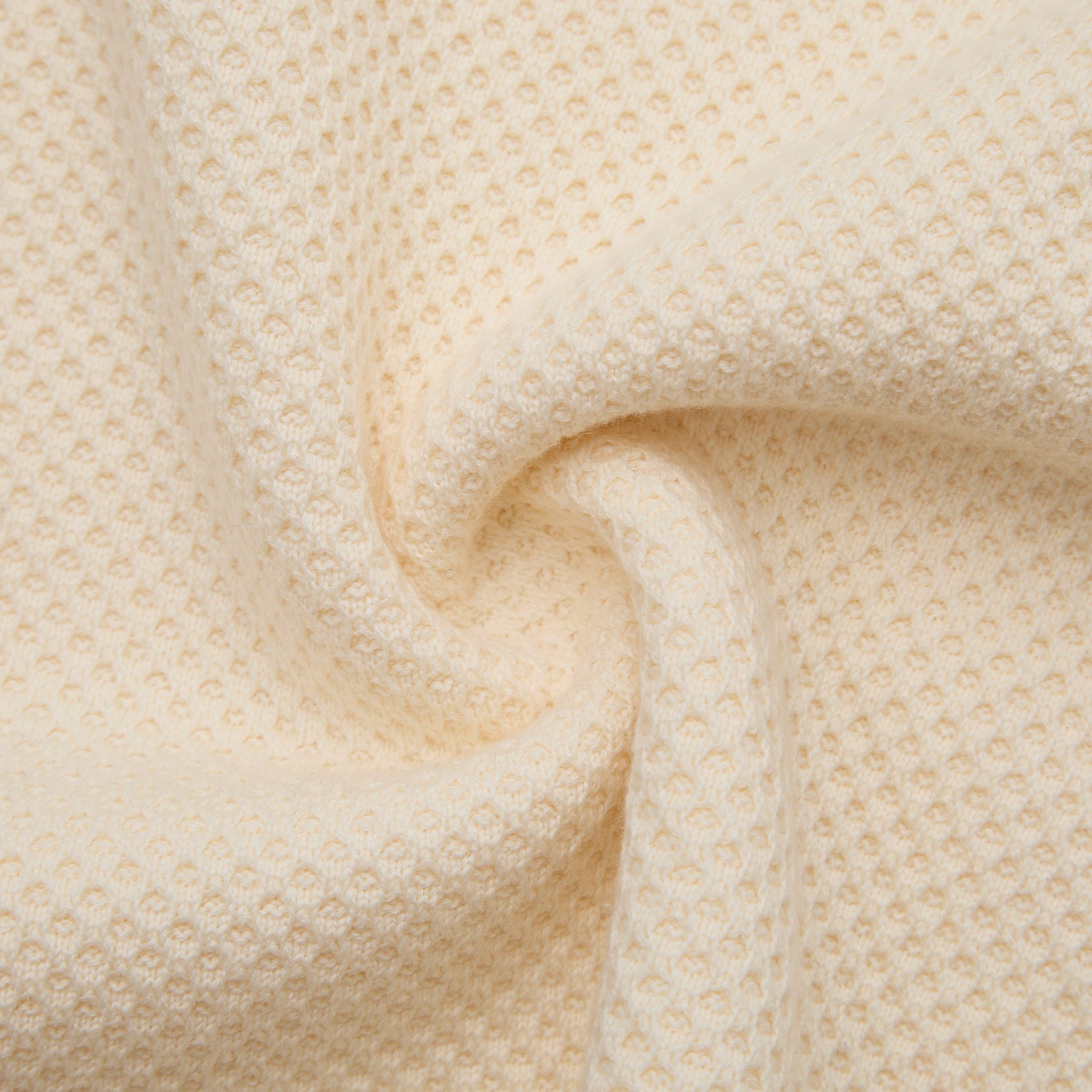 Close-up of beige textured fabric with a subtle pattern