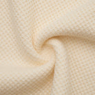 Close-up of beige textured fabric with a subtle pattern