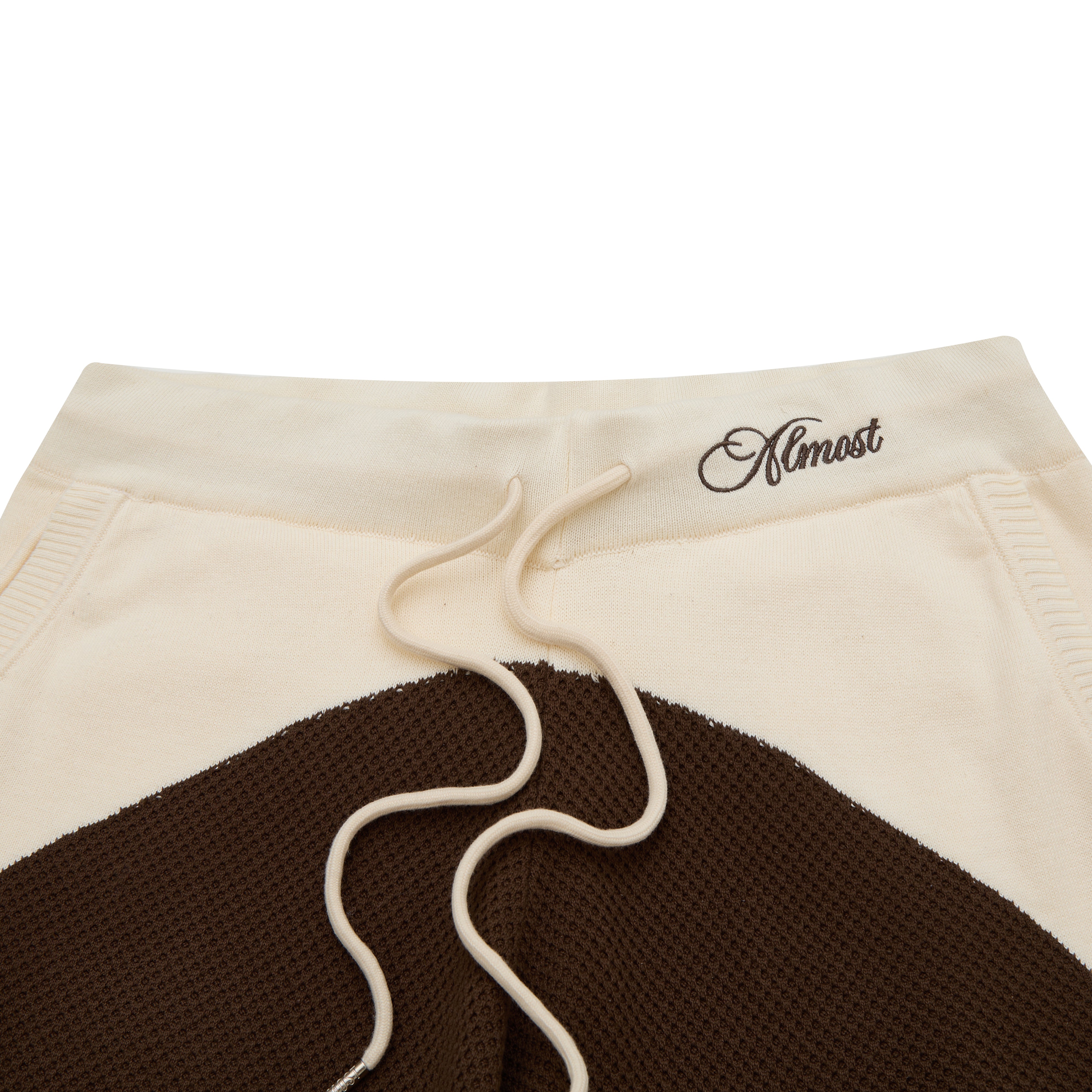 Shorts with a brown and beige design and 'Almost' text on a white background