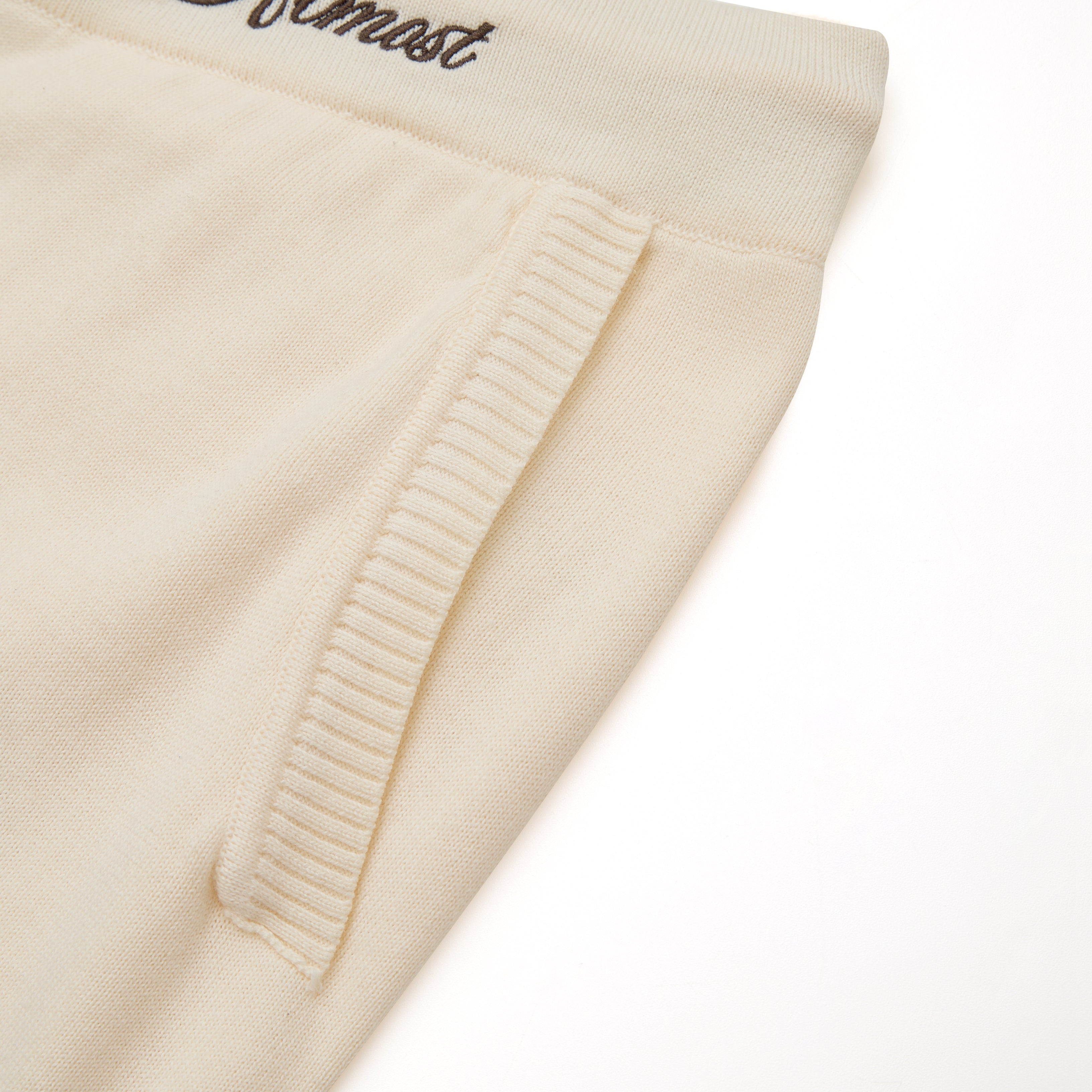 Close-up of beige fabric with a textured edge on a white background