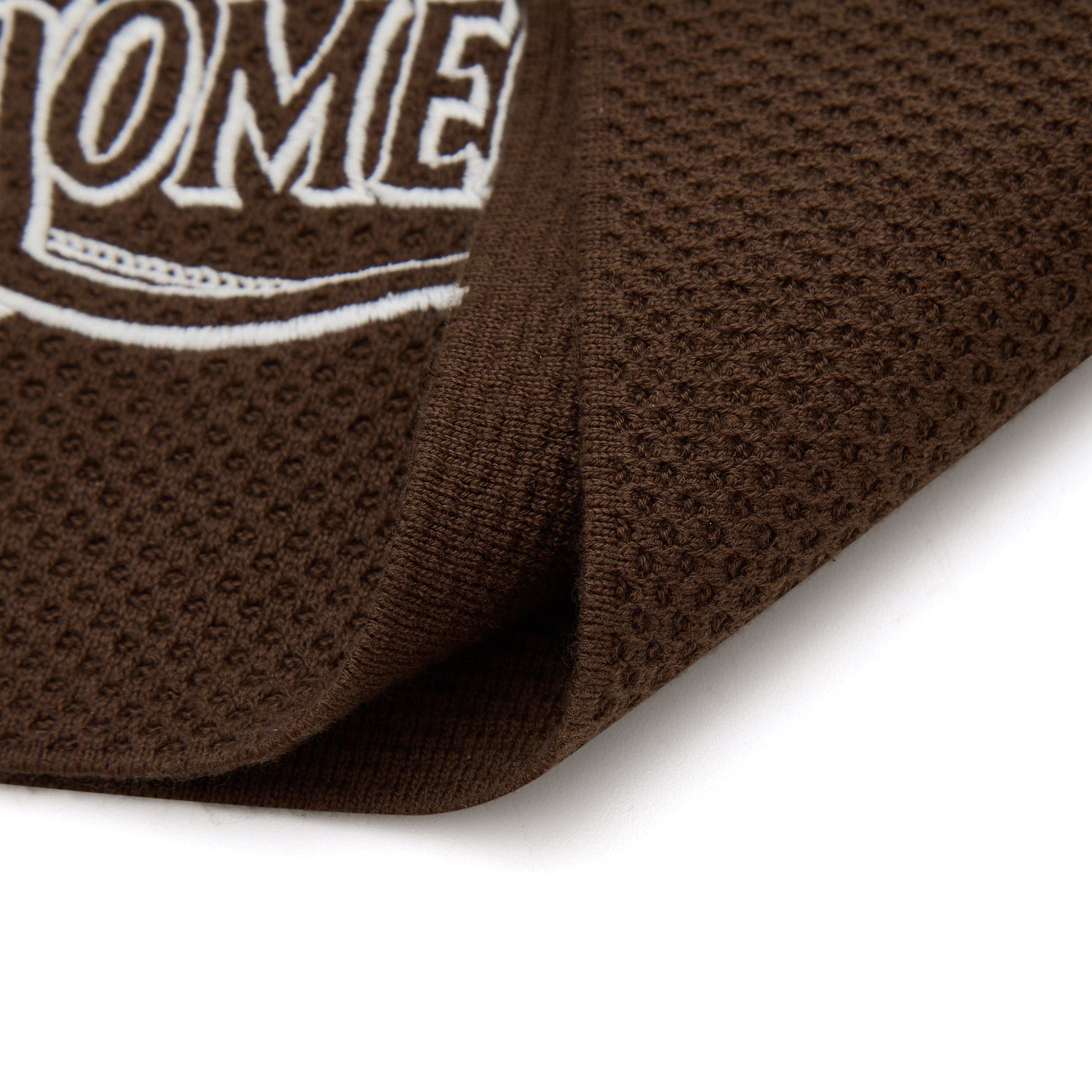 Brown textured mat with 'SOMEDAY' text on a white background