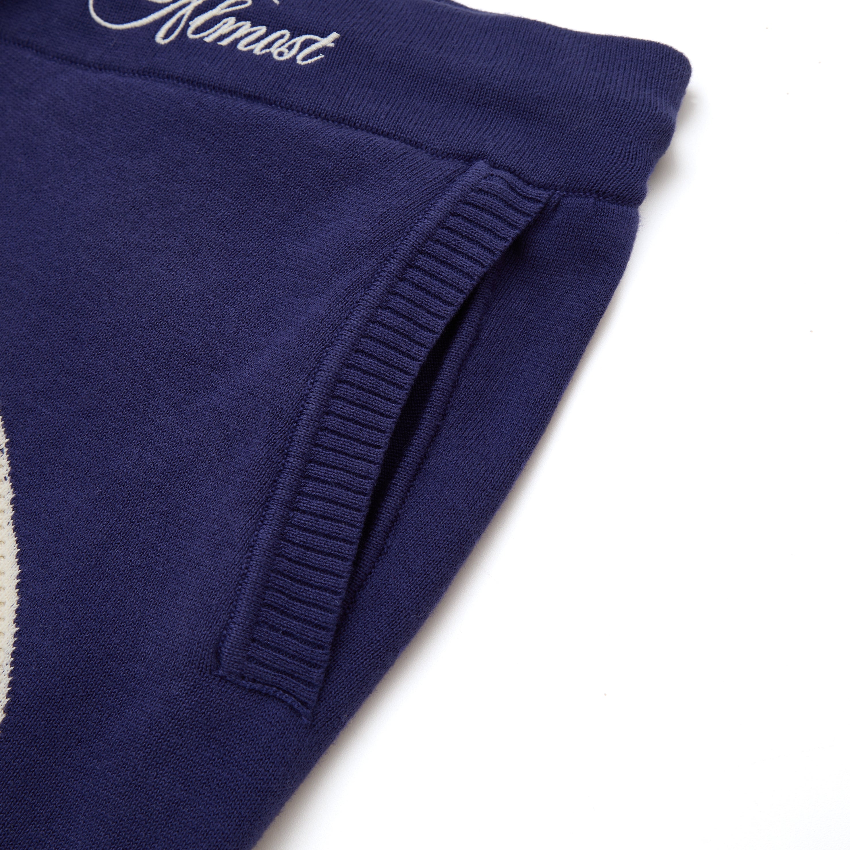 Navy blue shorts with ribbed cuffs on a white background