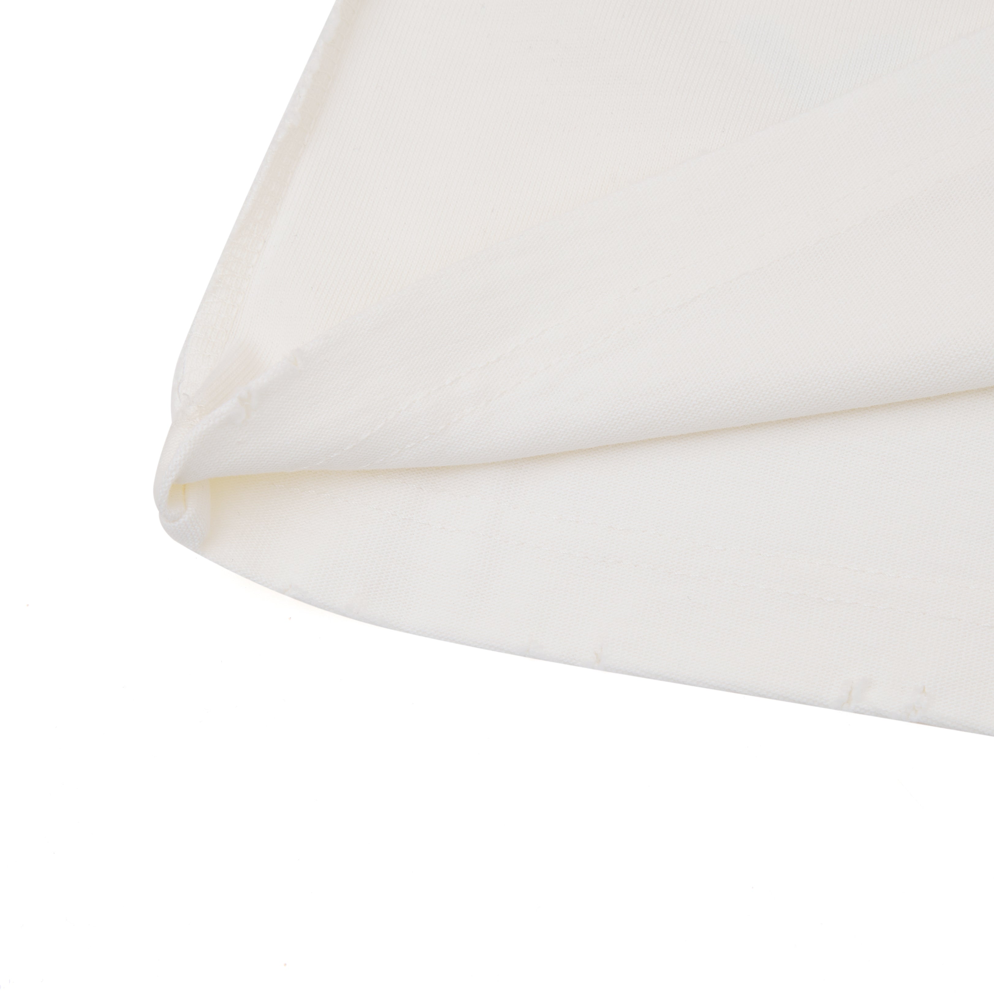 Close-up of a white pillow with a subtle pattern on a white background