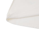 Close-up of a white pillow with a subtle pattern on a white background