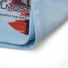 Close-up of a blue sweatshort fabric with text and graphics on a white background