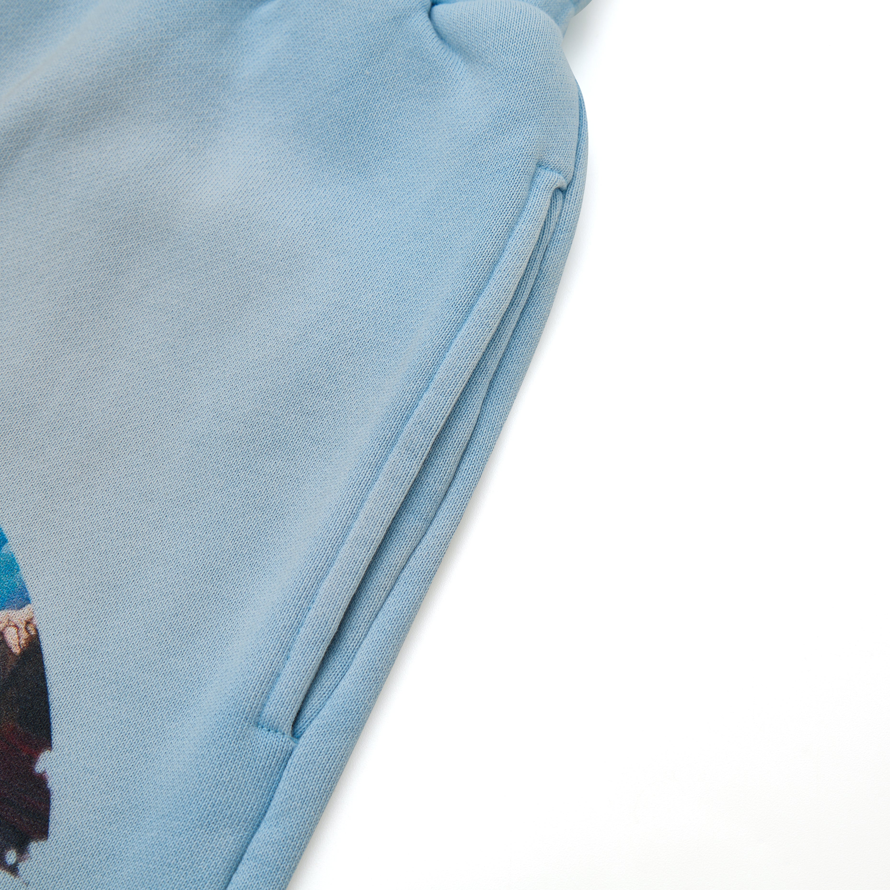 Close-up of a light blue fabric with a zipper on a white background
