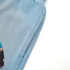 Close-up of a light blue fabric with a zipper on a white background