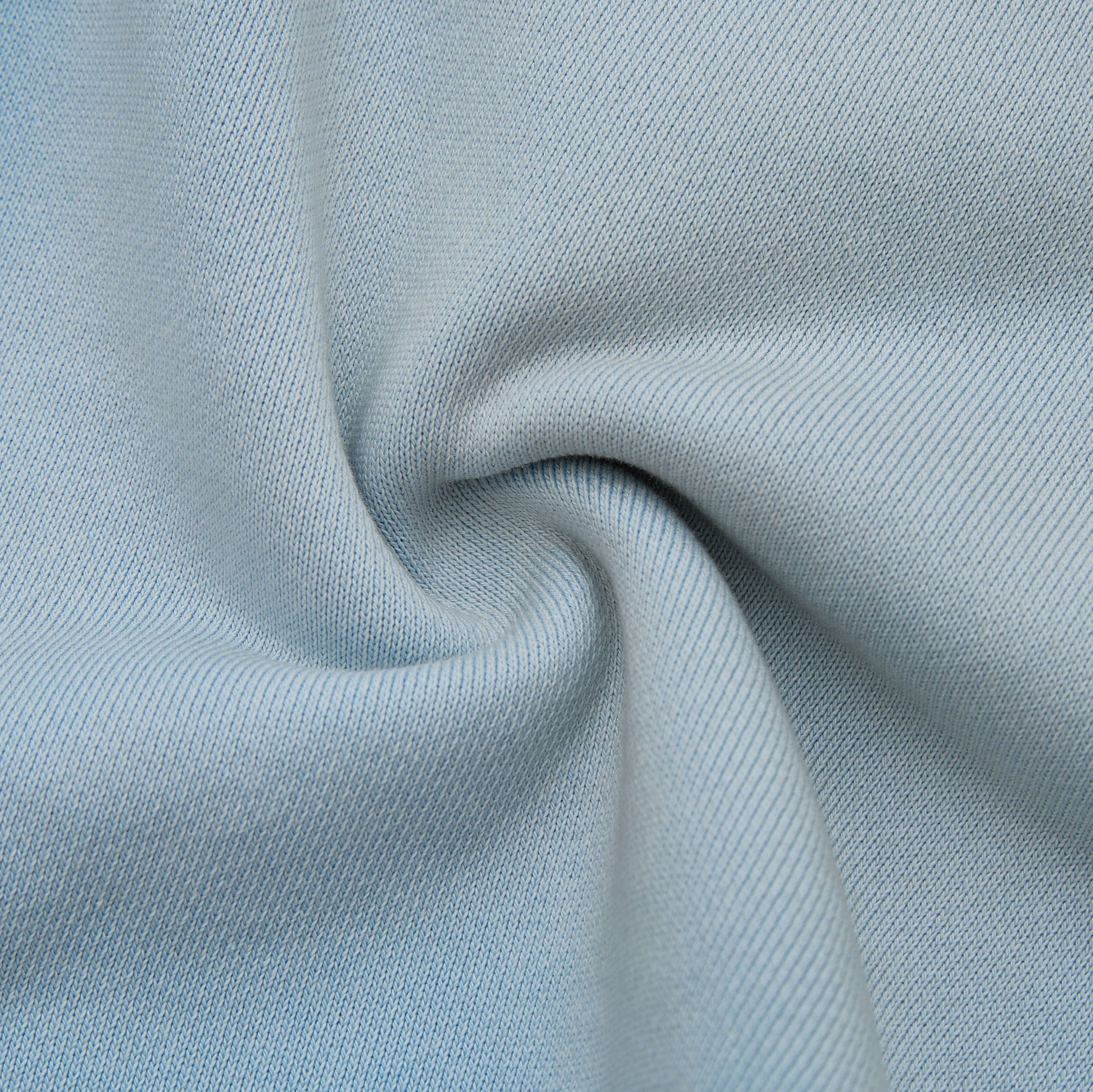 Close-up of light blue fabric with a subtle texture