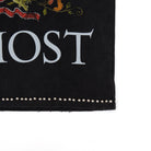 Black fabric with white text 'ALMOST' and decorative elements on a white background