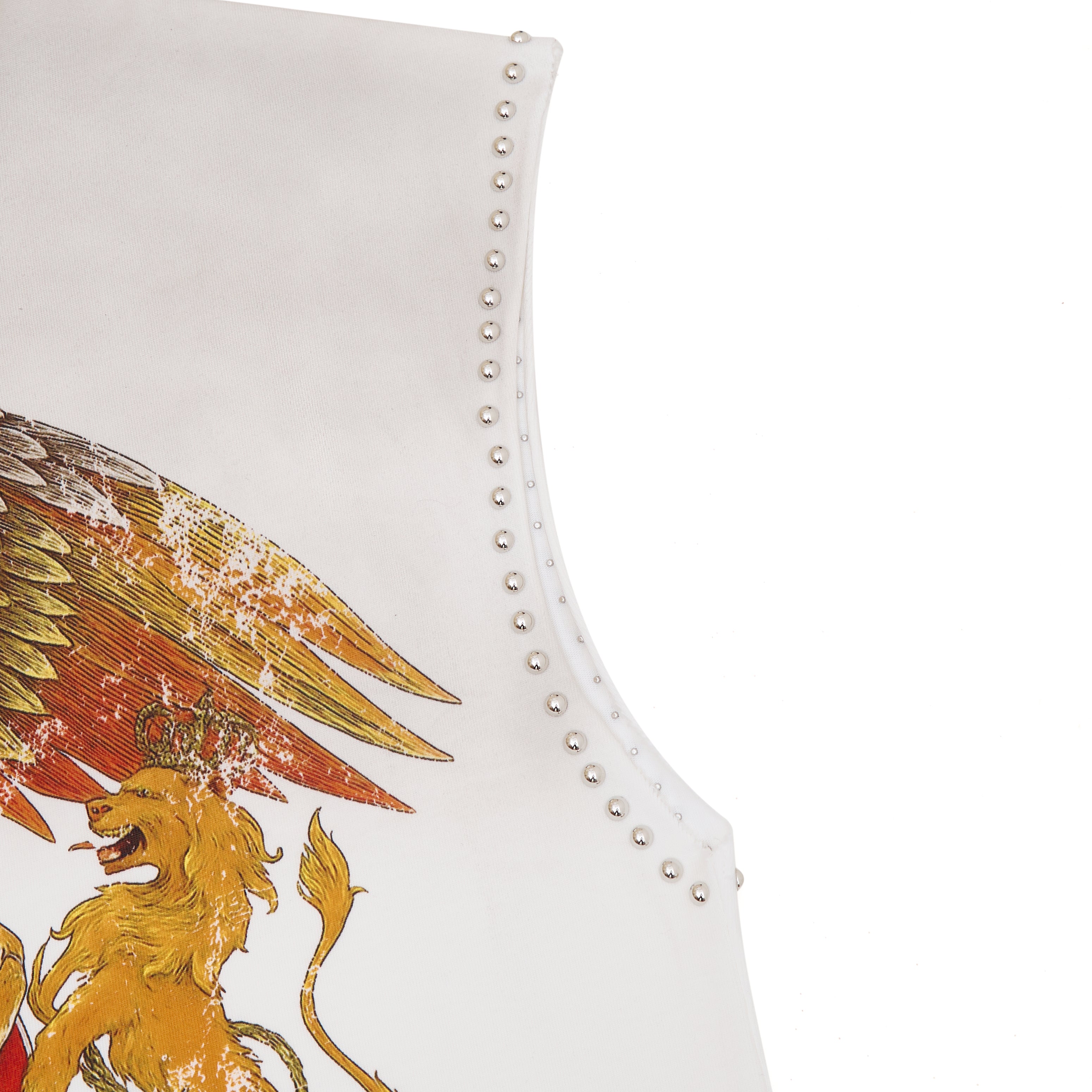 White garment with gold lion and eagle design and studded details on a white background