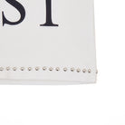 White clutch with studded details on a white background