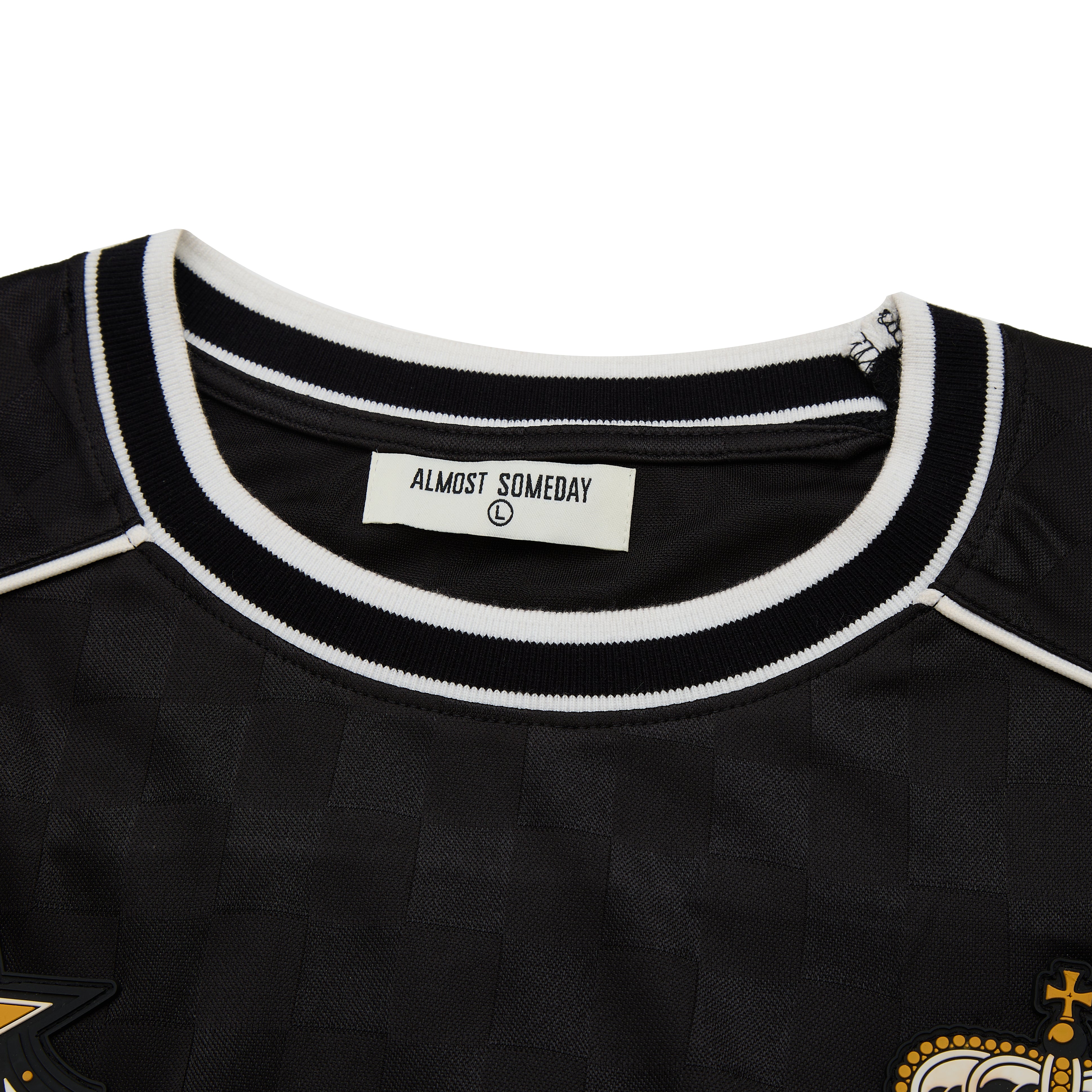 Black shirt with white trim and 'Almost Someday' label on a white background