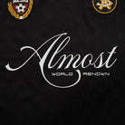 Black background with 'Almost World Renown' text and two logos.