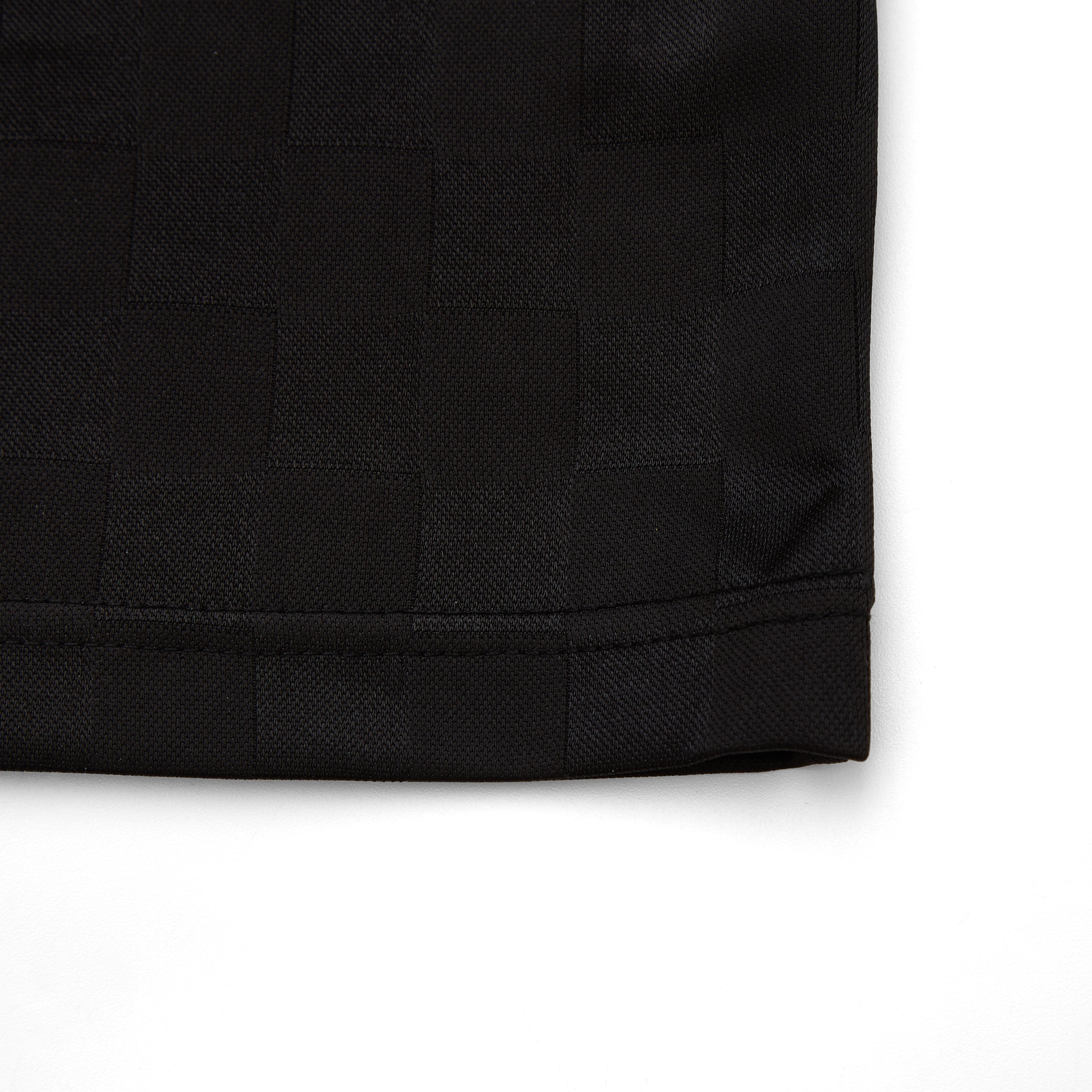 Close-up of a black textured fabric corner on a white background